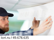 happy male technician repairing air conditioner with screwdriver. Стоковое фото, агентство Ingram Publishing / Фотобанк Лори