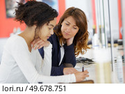 female student studying with teacher. Стоковое фото, агентство Ingram Publishing / Фотобанк Лори