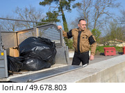 happy working man standing near dustbin on street. Стоковое фото, агентство Ingram Publishing / Фотобанк Лори
