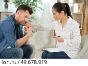 female psychiatrist holding stressed patients hands. Стоковое фото, агентство Ingram Publishing / Фотобанк Лори