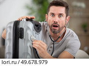 man using stethoscope on his suitcase. Стоковое фото, агентство Ingram Publishing / Фотобанк Лори