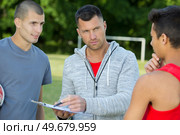 football coach assigning the players. Стоковое фото, агентство Ingram Publishing / Фотобанк Лори
