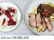 Veal meat roasted in fruit sauce. Top view. Beef meat baked with kiwi and pomegranate. Стоковое фото, агентство Ingram Publishing / Фотобанк Лори