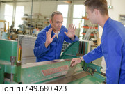 a young machine operator with manager. Стоковое фото, агентство Ingram Publishing / Фотобанк Лори
