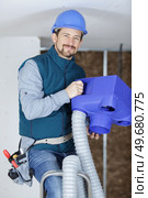 male technician repairing industrial air conditioner indoors. Стоковое фото, агентство Ingram Publishing / Фотобанк Лори