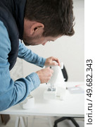 a man fixes a machine. Стоковое фото, агентство Ingram Publishing / Фотобанк Лори