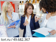 portrait of trainee hairdresser smelling product. Стоковое фото, агентство Ingram Publishing / Фотобанк Лори