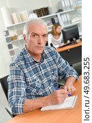 Senior man writing at his desk. Стоковое фото, агентство Ingram Publishing / Фотобанк Лори