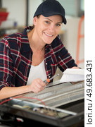 female technician working on dismantled heater. Стоковое фото, агентство Ingram Publishing / Фотобанк Лори