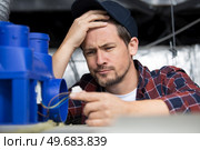 skilled worker having problems while replacing defective pipe. Стоковое фото, агентство Ingram Publishing / Фотобанк Лори