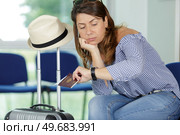 women express bored feeling at airport after delay flight. Стоковое фото, агентство Ingram Publishing / Фотобанк Лори
