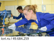 young qualified people forced to work at the factory. Стоковое фото, агентство Ingram Publishing / Фотобанк Лори