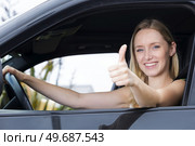 happy young woman in convertible car thumbs up. Стоковое фото, агентство Ingram Publishing / Фотобанк Лори