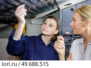 young woman airplane pilot checkin some digits. Стоковое фото, агентство Ingram Publishing / Фотобанк Лори
