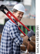 a working fitter holds pliers for building works. Стоковое фото, агентство Ingram Publishing / Фотобанк Лори