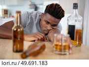 young drunk man is slumped across the table. Стоковое фото, агентство Ingram Publishing / Фотобанк Лори