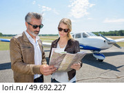 two modern aircraft engineers looking at map. Стоковое фото, агентство Ingram Publishing / Фотобанк Лори