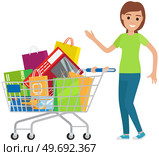 Happy woman with shopping cart. Purchases, goods, gift packages in trolley. Female character enjoying lot of purchases. Shopping, buying goods in store concept. Smiling girl near cart with goods. Happy woman with shopping cart. Female character enjoying purchases, goods, gift packages in trolley. Стоковая иллюстрация, агентство Ingram Publishing / Фотобанк Лори