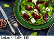 Beetroot salad with beets, blue cheese, herbs and pine nuts on the green plate. Salad with beet, blue cheese and pine nuts. Стоковое фото, агентство Ingram Publishing / Фотобанк Лори