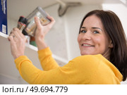 beautiful young woman getting out of the cupboard a jar. Стоковое фото, агентство Ingram Publishing / Фотобанк Лори