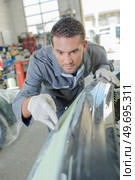 Mechanic working on the body work. Стоковое фото, агентство Ingram Publishing / Фотобанк Лори