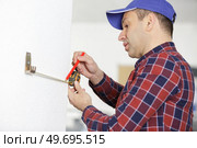 man using measurement tape for home improvement. Стоковое фото, агентство Ingram Publishing / Фотобанк Лори