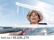 woman in glider waiting looking out at landscape. Стоковое фото, агентство Ingram Publishing / Фотобанк Лори