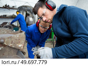 metalworker with training woman in factory. Стоковое фото, агентство Ingram Publishing / Фотобанк Лори