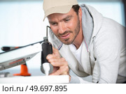 young repairman working at the kitchen. Стоковое фото, агентство Ingram Publishing / Фотобанк Лори