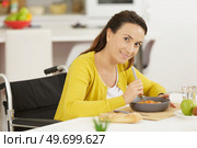 woman in wheelchair having lunch. Стоковое фото, агентство Ingram Publishing / Фотобанк Лори