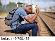 sad young man at the railway station. Стоковое фото, агентство Ingram Publishing / Фотобанк Лори