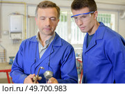 Tutor and apprentice with gas burner. Стоковое фото, агентство Ingram Publishing / Фотобанк Лори