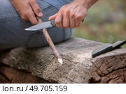 cropped image of hands whittling a stick with a knife. Стоковое фото, агентство Ingram Publishing / Фотобанк Лори