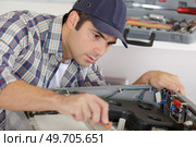 a craftsman is working in a kitchen. Стоковое фото, агентство Ingram Publishing / Фотобанк Лори