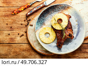 Meat steak on the rib fried with pineapple. American cuisine.. Roasted meat with pineapple. Стоковое фото, агентство Ingram Publishing / Фотобанк Лори