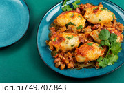 Delicious stuffed squid or calamari with salsa sauce on a plate.. Grilled stuffed squid in sauce. Стоковое фото, агентство Ingram Publishing / Фотобанк Лори