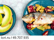 Baked dorado fish or gilt-head bream with melon on a light background. Healthy food. Dorado fish roasted with melon. Стоковое фото, агентство Ingram Publishing / Фотобанк Лори