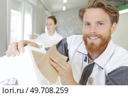 skilled furniture maker sanding a wooden chair. Стоковое фото, агентство Ingram Publishing / Фотобанк Лори