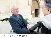Elderly couple in wheelchairs outside of a church. Стоковое фото, агентство Ingram Publishing / Фотобанк Лори