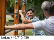 men exercise on outdoor gym in the park. Стоковое фото, агентство Ingram Publishing / Фотобанк Лори
