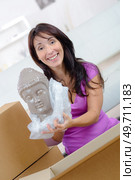 woman unpacking online purchase at home. Стоковое фото, агентство Ingram Publishing / Фотобанк Лори