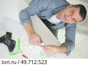 high-angle view of man assembling a drone. Стоковое фото, агентство Ingram Publishing / Фотобанк Лори