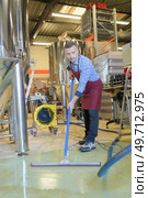 portrait of factory worker cleaning floor. Стоковое фото, агентство Ingram Publishing / Фотобанк Лори