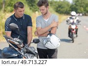 young man learning to drive motorbike with instructor. Стоковое фото, агентство Ingram Publishing / Фотобанк Лори