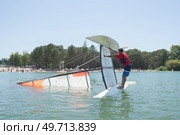 salior trying to right his catamaran after capsize. Стоковое фото, агентство Ingram Publishing / Фотобанк Лори