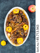 Pork knuckle or knee cooked in dark beer and apples. Top view.. Homemade roasted pork knuckle. Стоковое фото, агентство Ingram Publishing / Фотобанк Лори