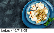 Baked young squids with nut garnish. Copy space. Korea traditional food.. Baked calamari with nuts, space for text. Стоковое фото, агентство Ingram Publishing / Фотобанк Лори