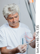 an electrician doing his thing. Стоковое фото, агентство Ingram Publishing / Фотобанк Лори