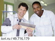 team of painters with a brush at work room. Стоковое фото, агентство Ingram Publishing / Фотобанк Лори