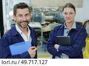 portrait of two cheerful workers in protective overalls. Стоковое фото, агентство Ingram Publishing / Фотобанк Лори